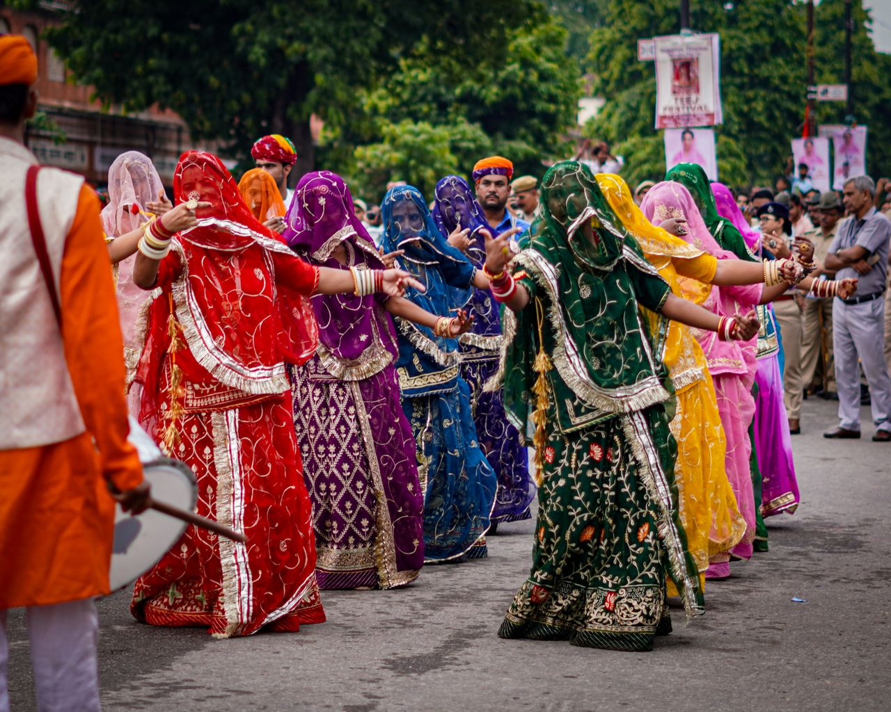 Vibrant traditional dancers in colorful attire participating in a street parade.