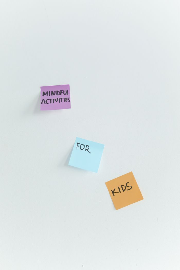 Sticky notes on a white surface promoting mindful activities for kids.